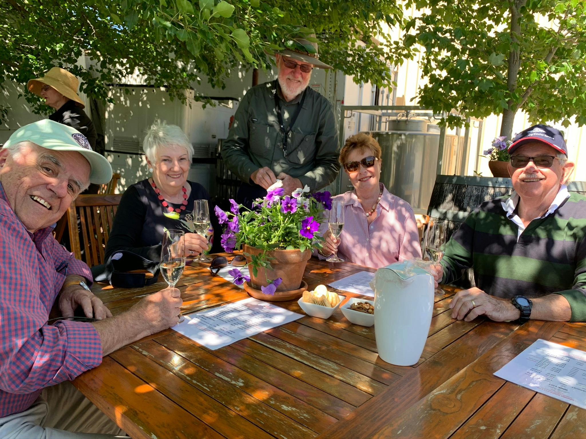 5 people sititng at table tasitng wine in Orange