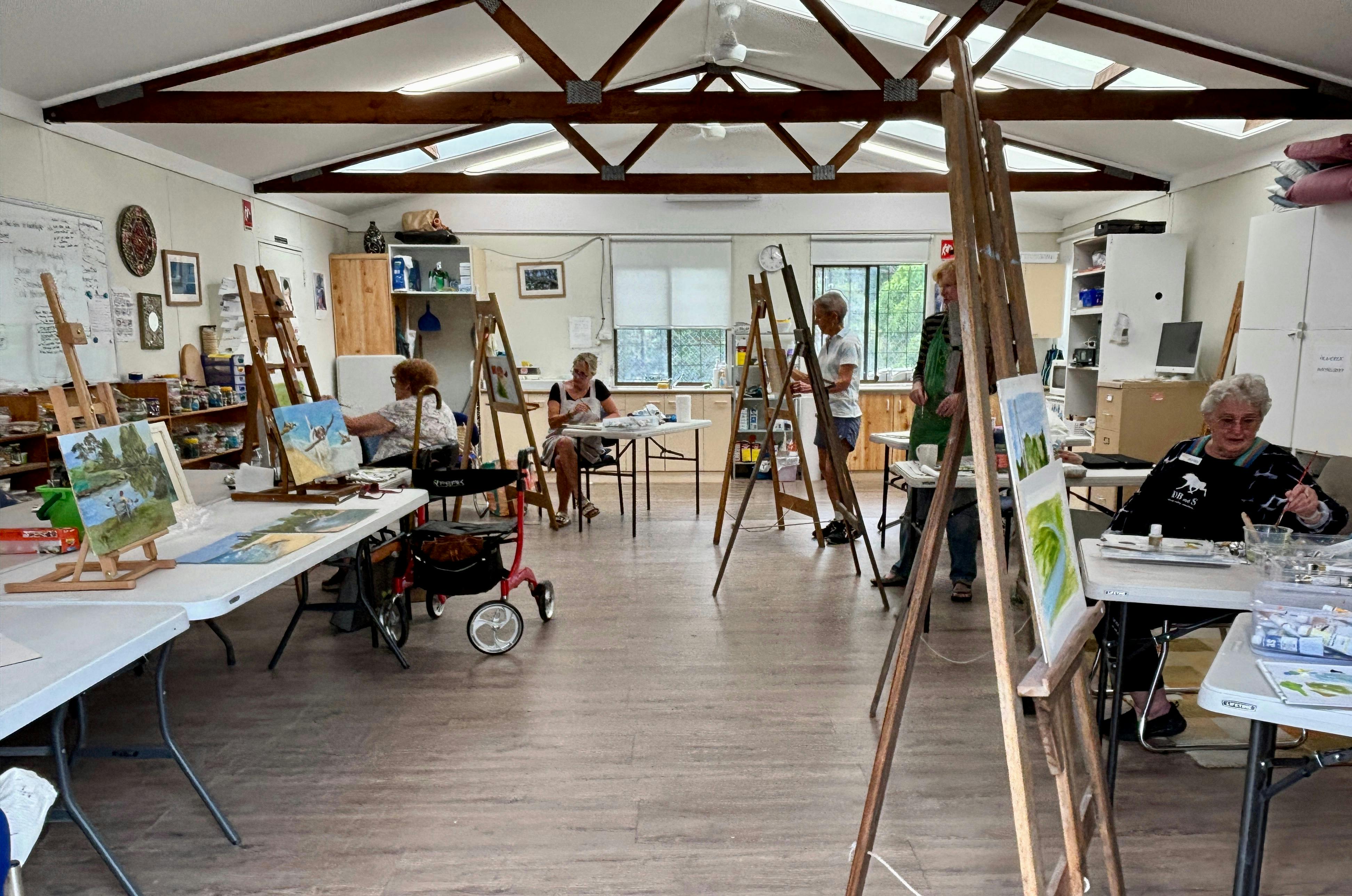 tables, chairs and painting easels set up in the studio during the oil and acrylic painting class