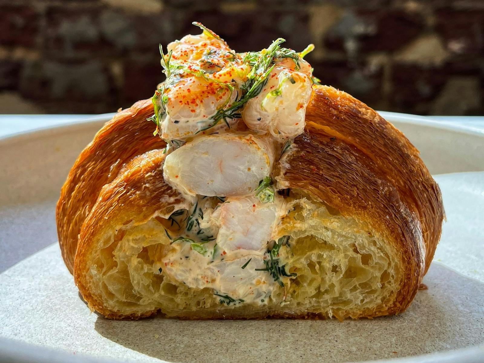 Locally made fresh croissant, filled with locally caught prawns.