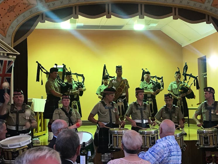 Pipers and drummers playing to an audience