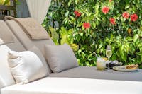 Pool Cabana surrounded by tropical gardens with tro[pical cocktails & fresh seafood