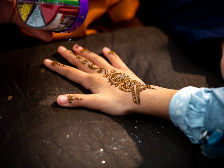 Girl with henna adorned on her hands