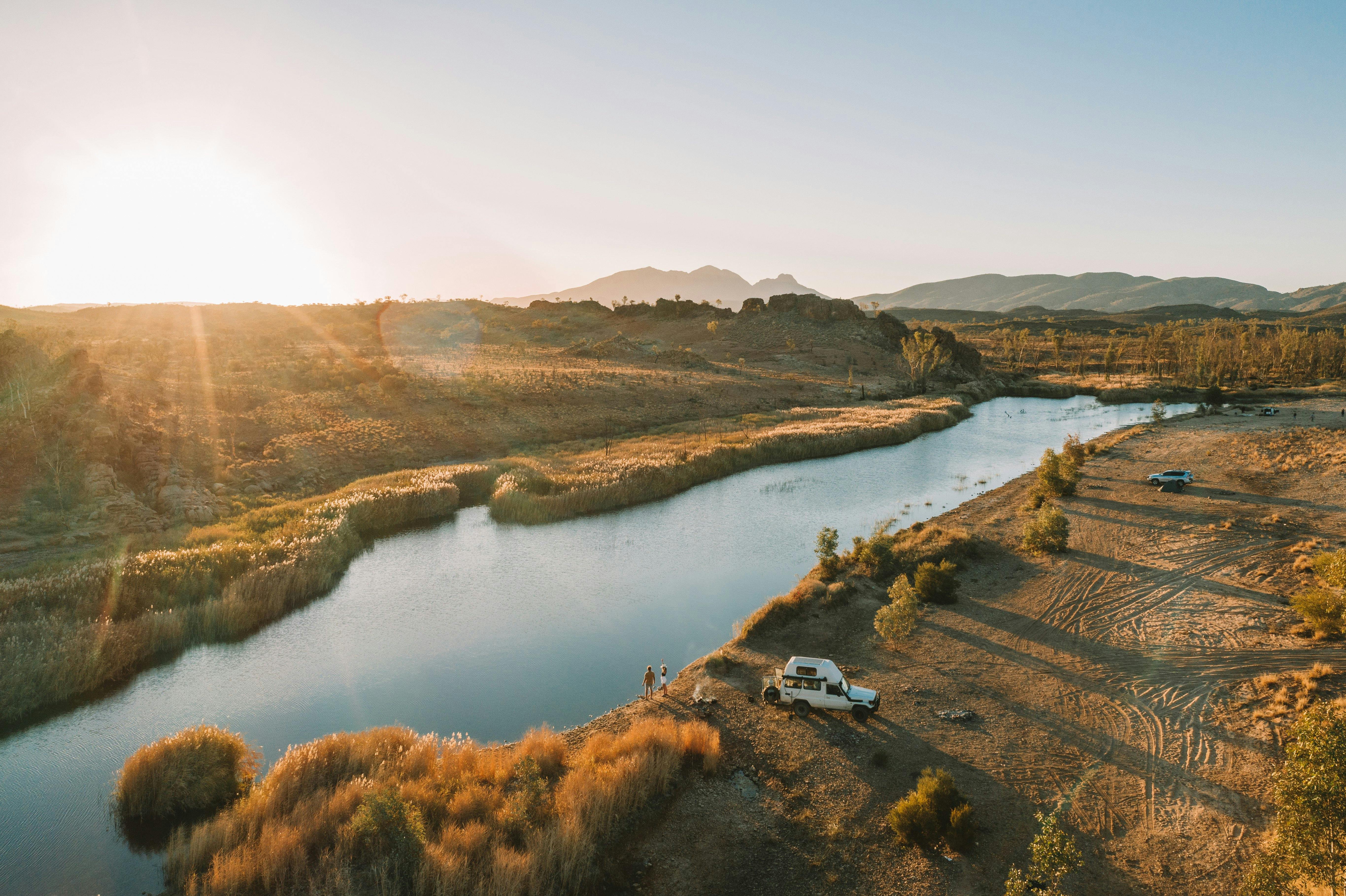 Aerial view of campers on the waters edge at Finke River 2 Mile at sunset