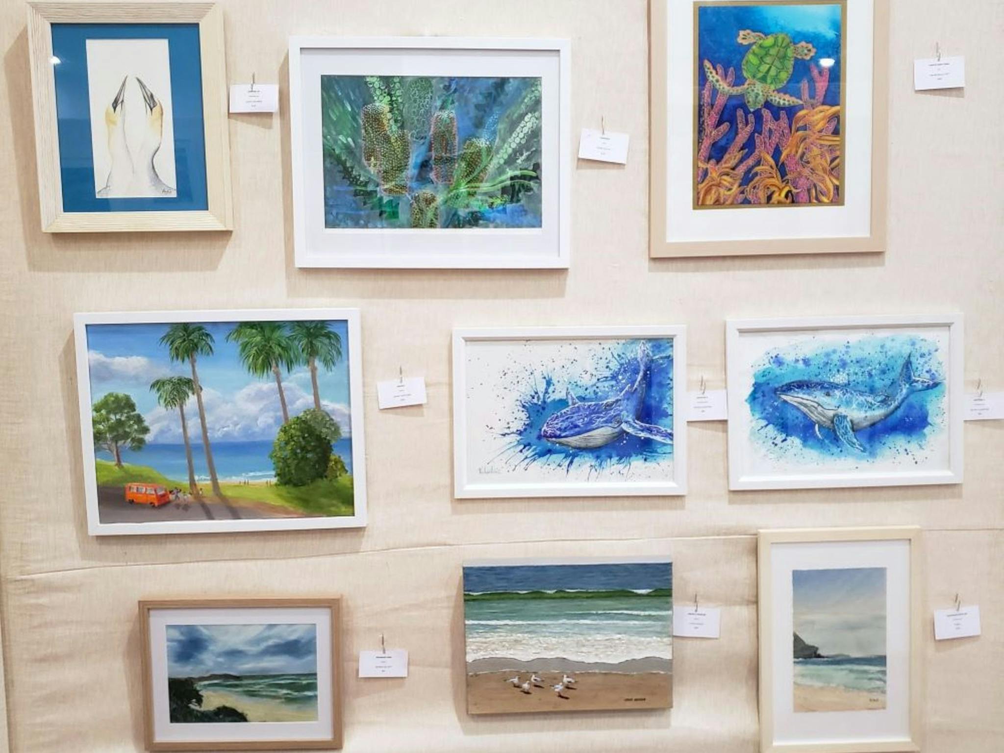 Image of multiple paintings on display at the arts centre