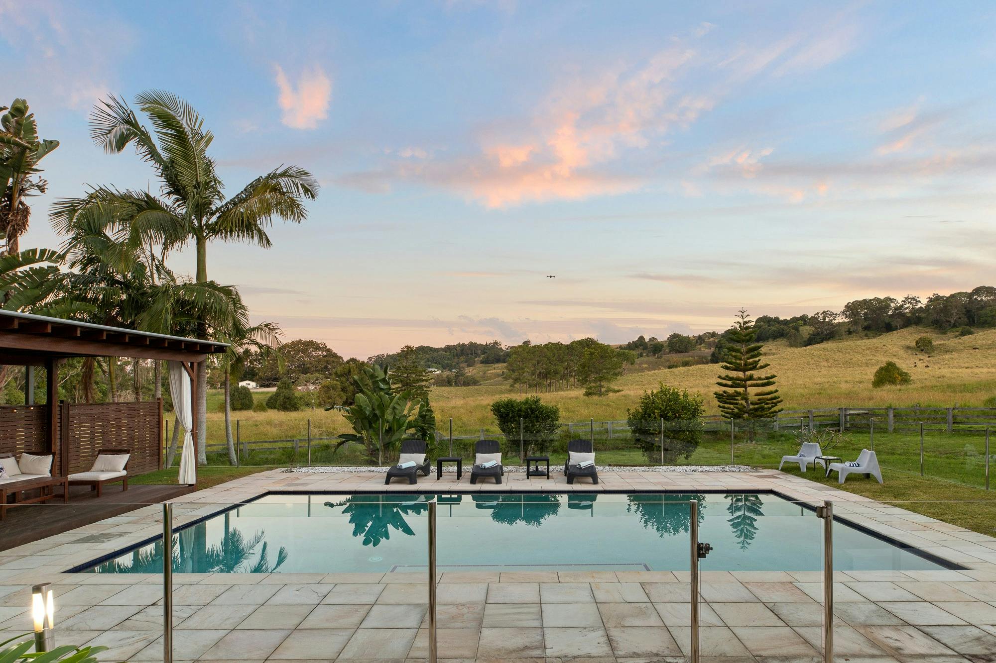 Expansive private saltwater pool surrounded by lush landscaping and tranquil outdoor space