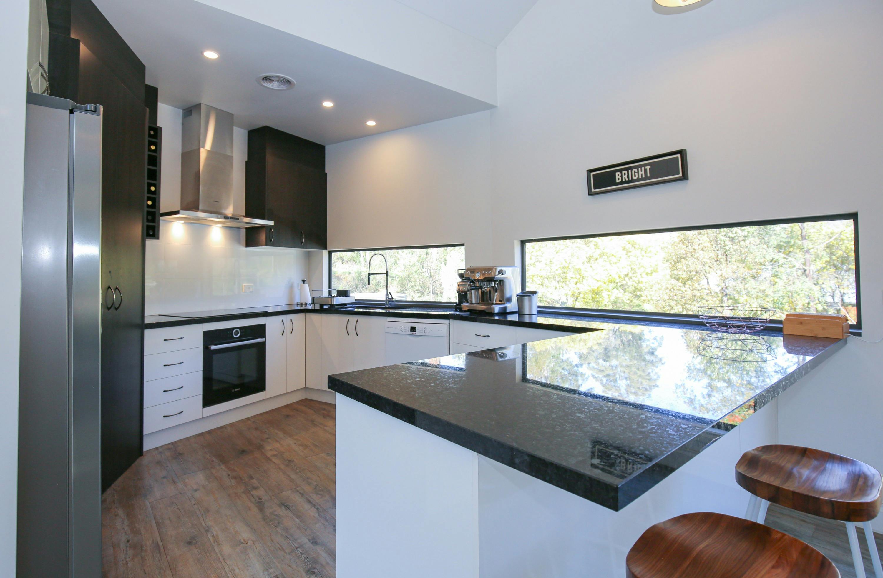 Northern Exposure Bright kitchen with coffee machine, dishwasher and oven