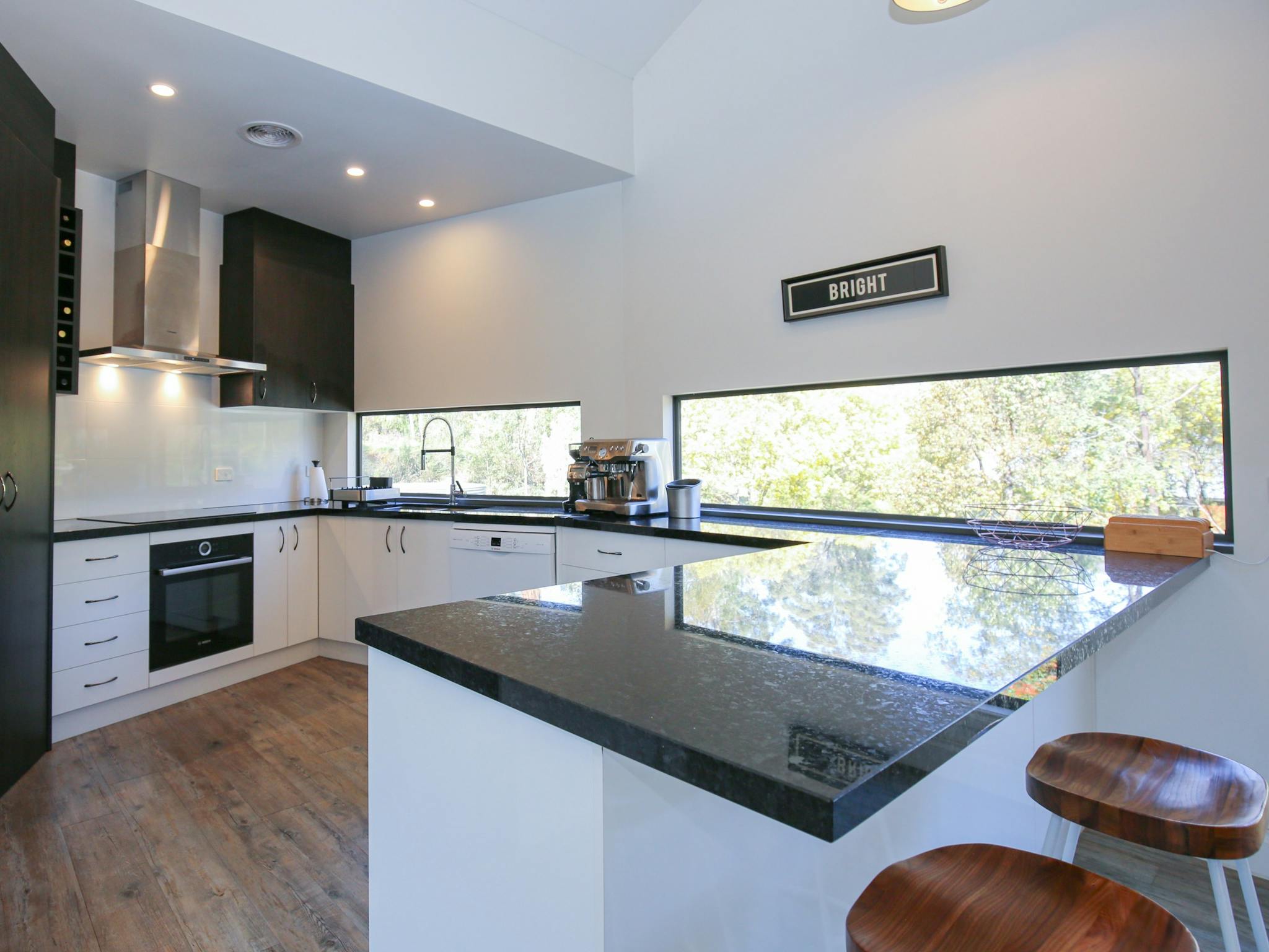 Northern Exposure Bright kitchen with coffee machine, dishwasher and oven