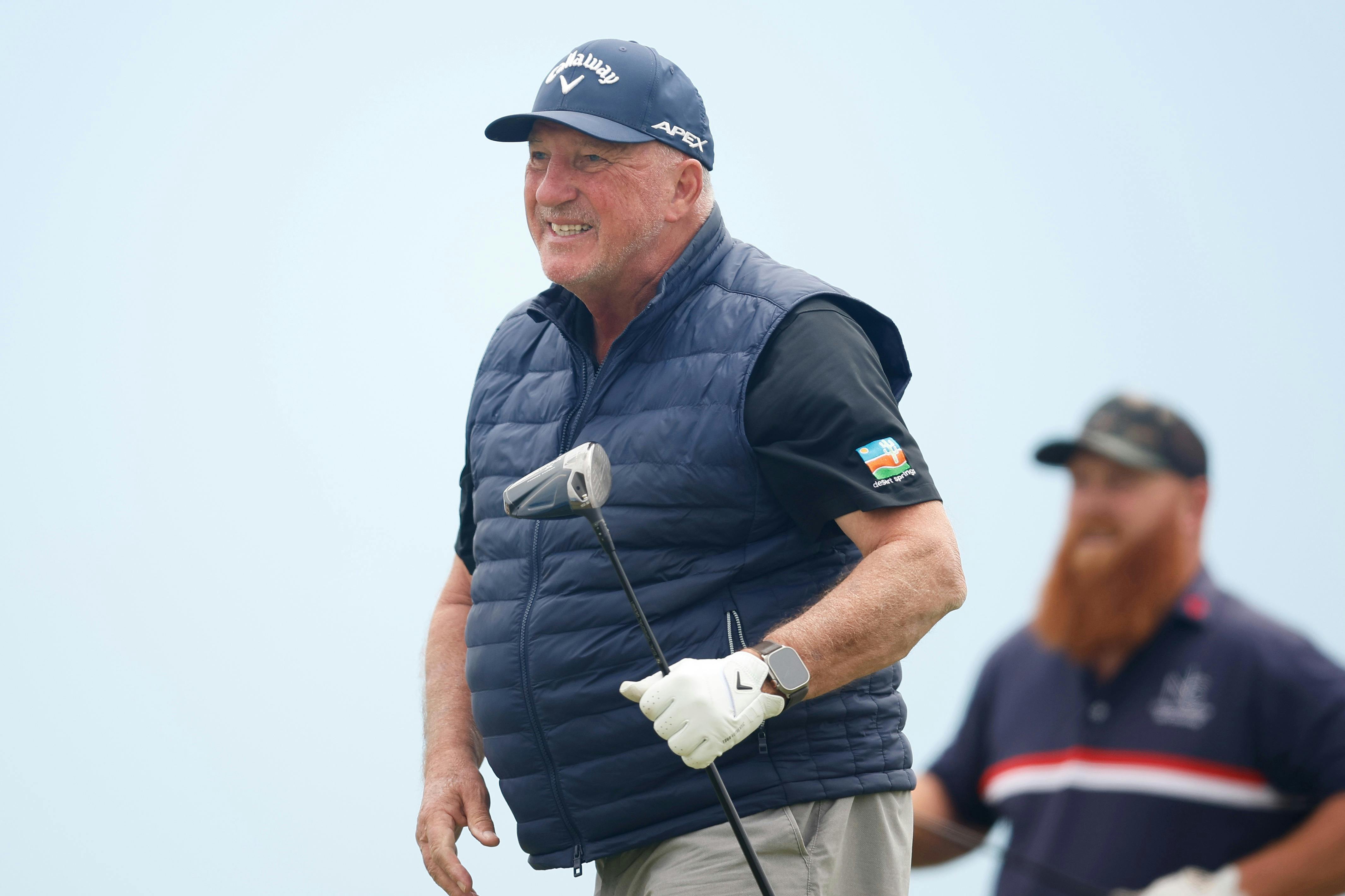 Sir Ian Botham holding a golf club