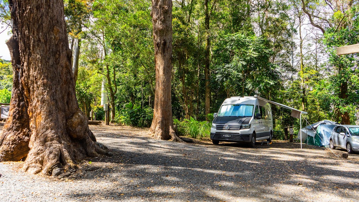 Image shows a campervan on a drive in site
