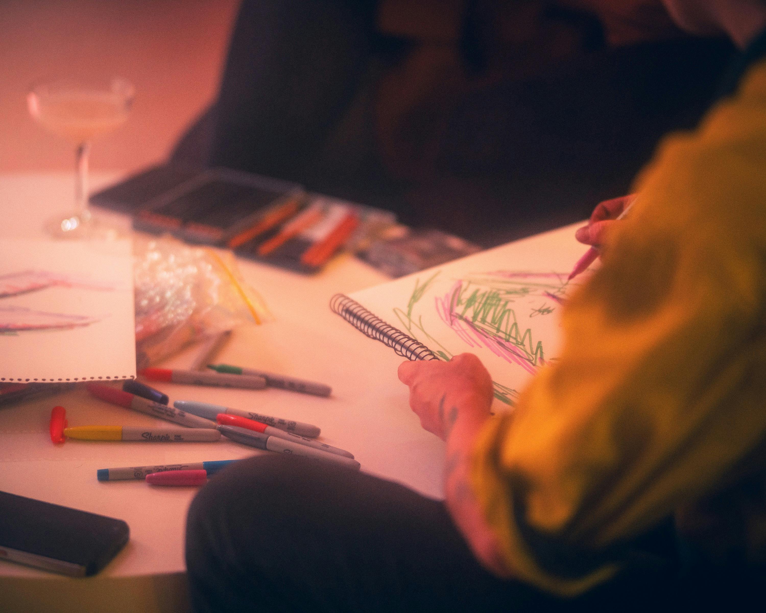 Person wearing hi-vis drawing using textas