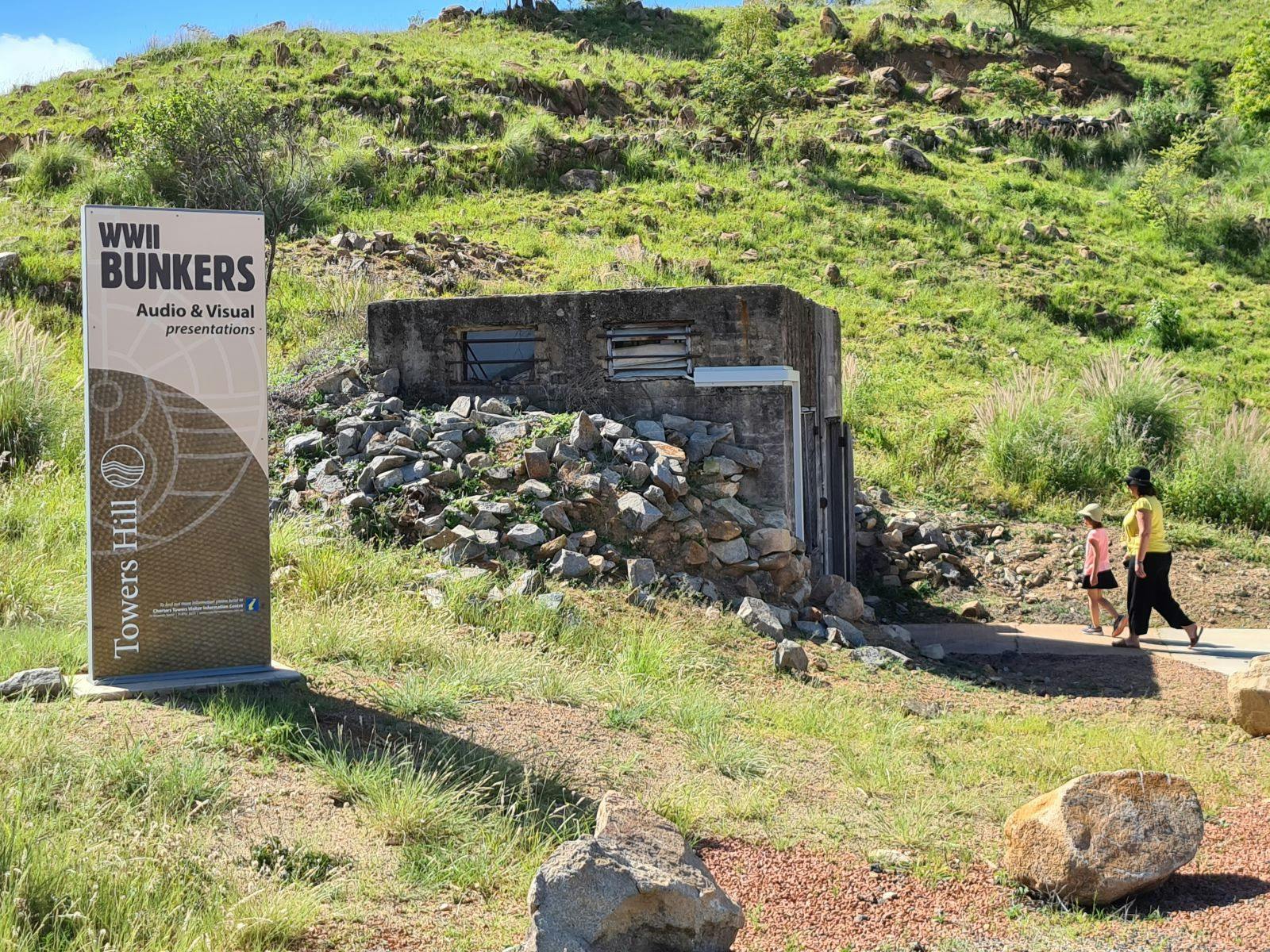 People walking into the WWII bunkers on Towers Hill Charters Towers