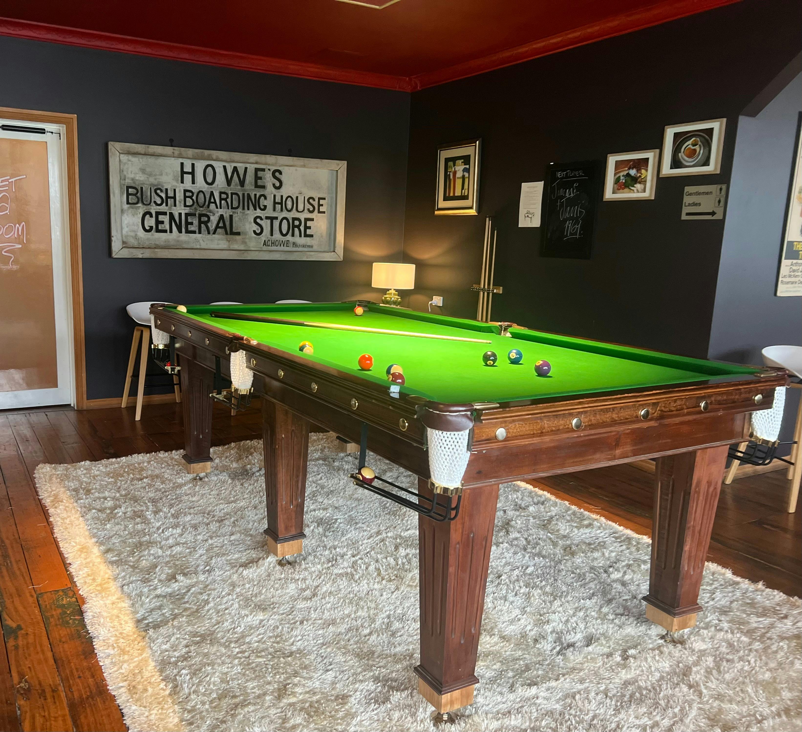 large slate pool table with subdued lighting