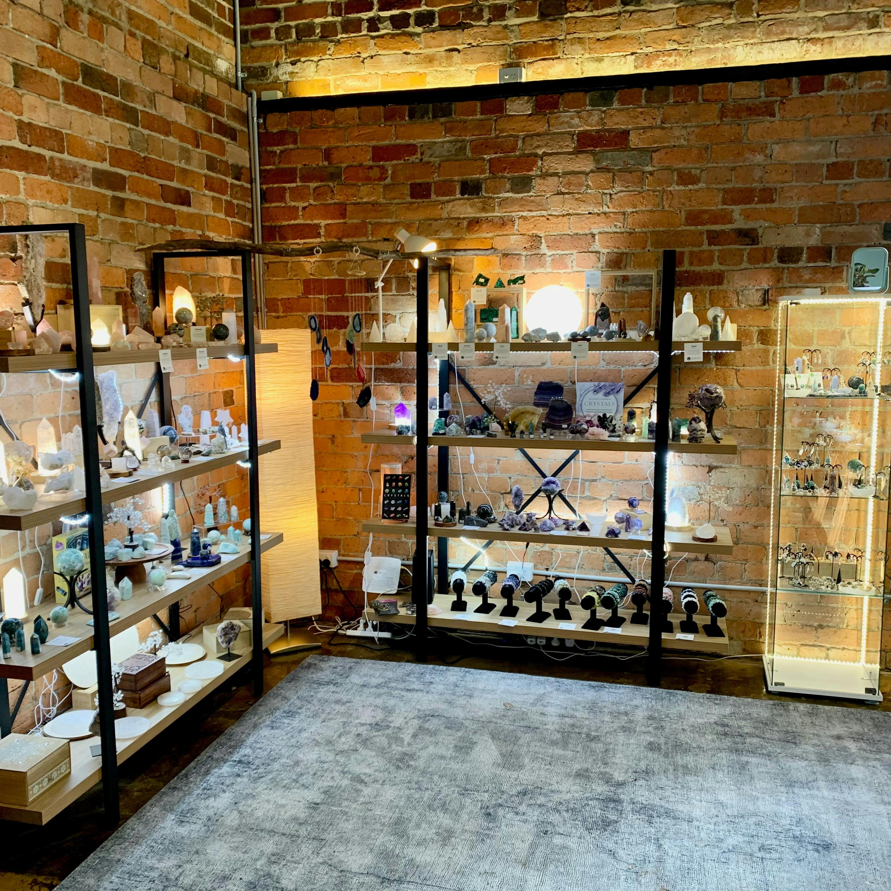 Shelving displaying crystals, lamps and jewellery.