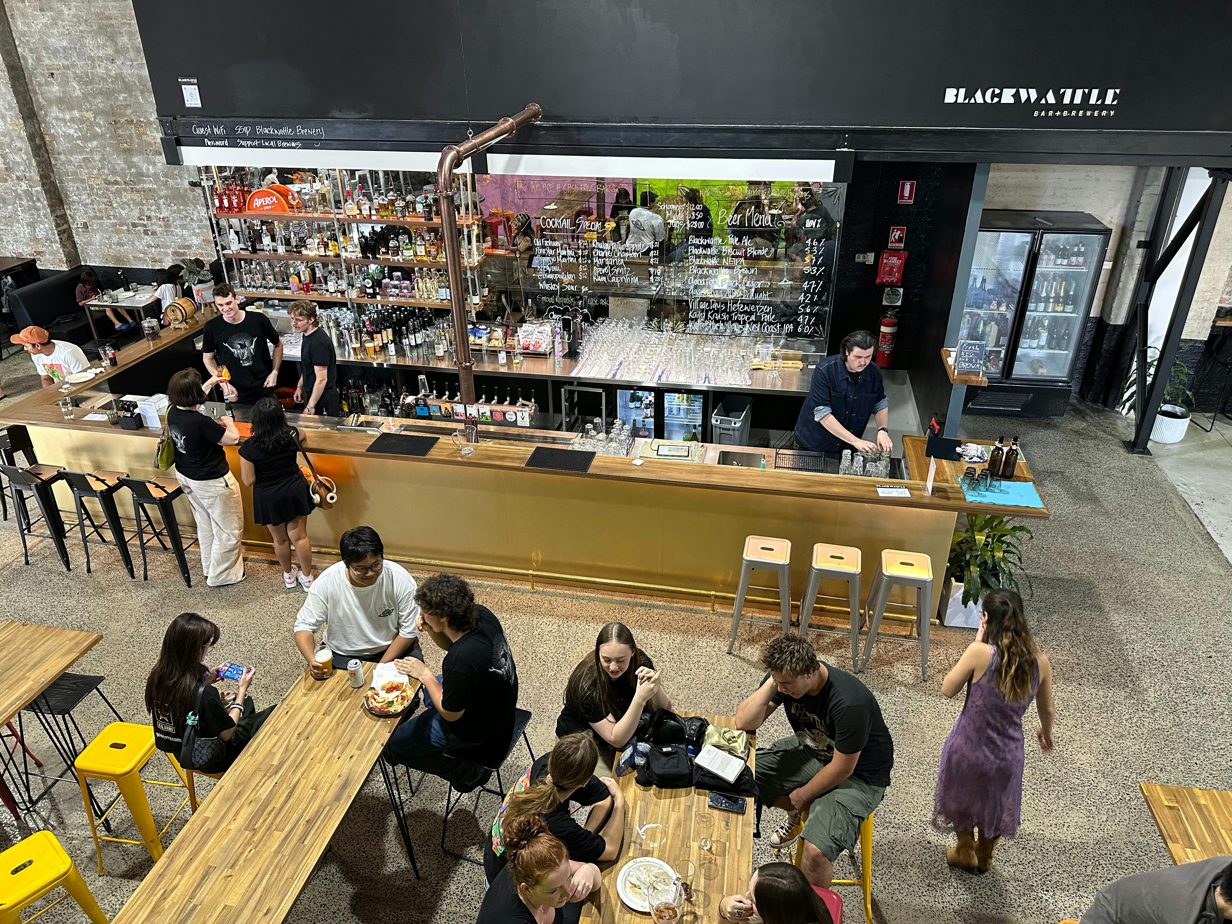 A picture of people sat around the bar area at Blackwattle Brewery