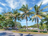 Blue sky and palm trees with Caravans in the distance