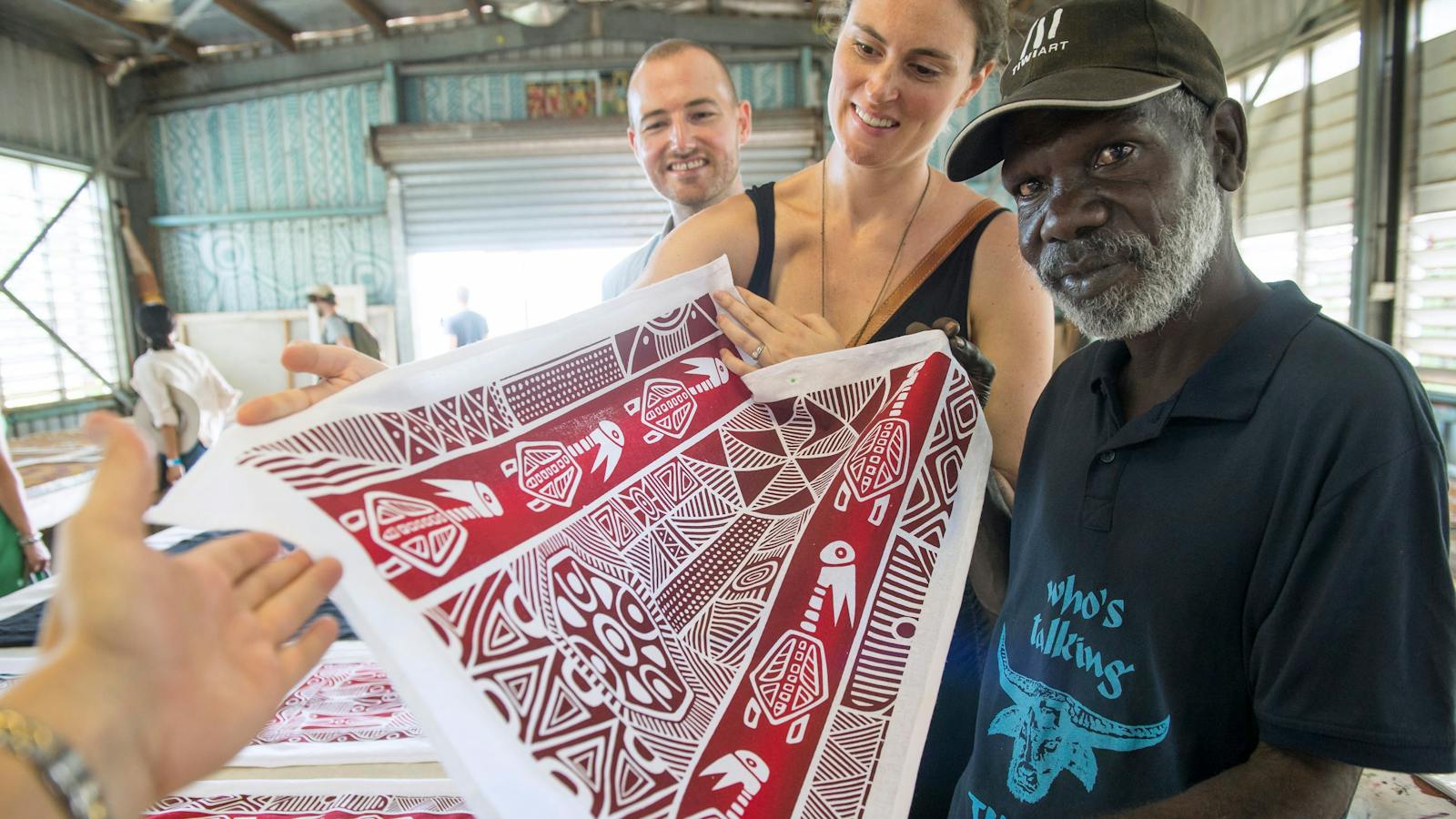 Tourists admiring Tiwi art with a local artist