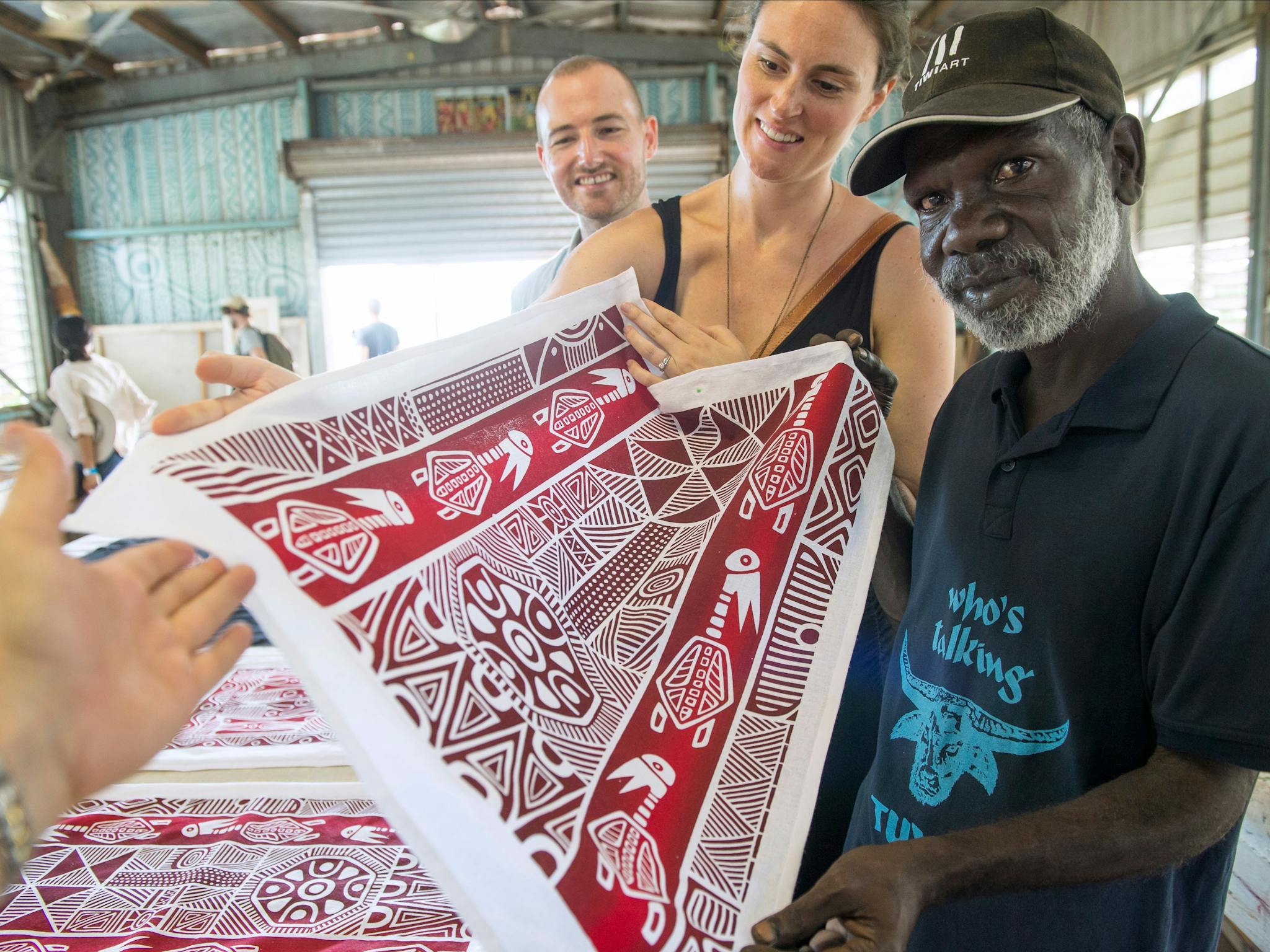 Tourists admiring Tiwi art with a local artist