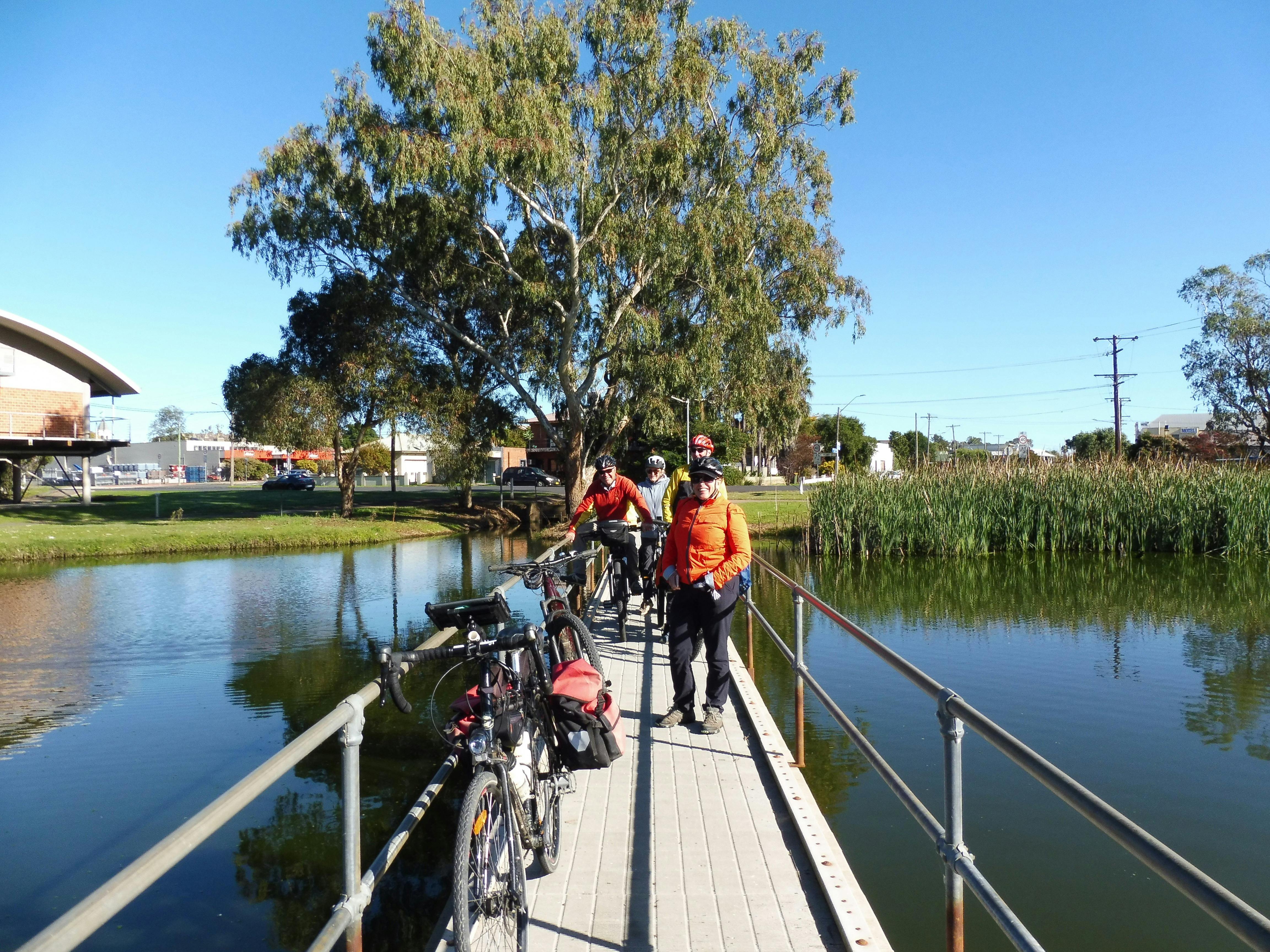 Cyclist crossing bridge Forbes Lake