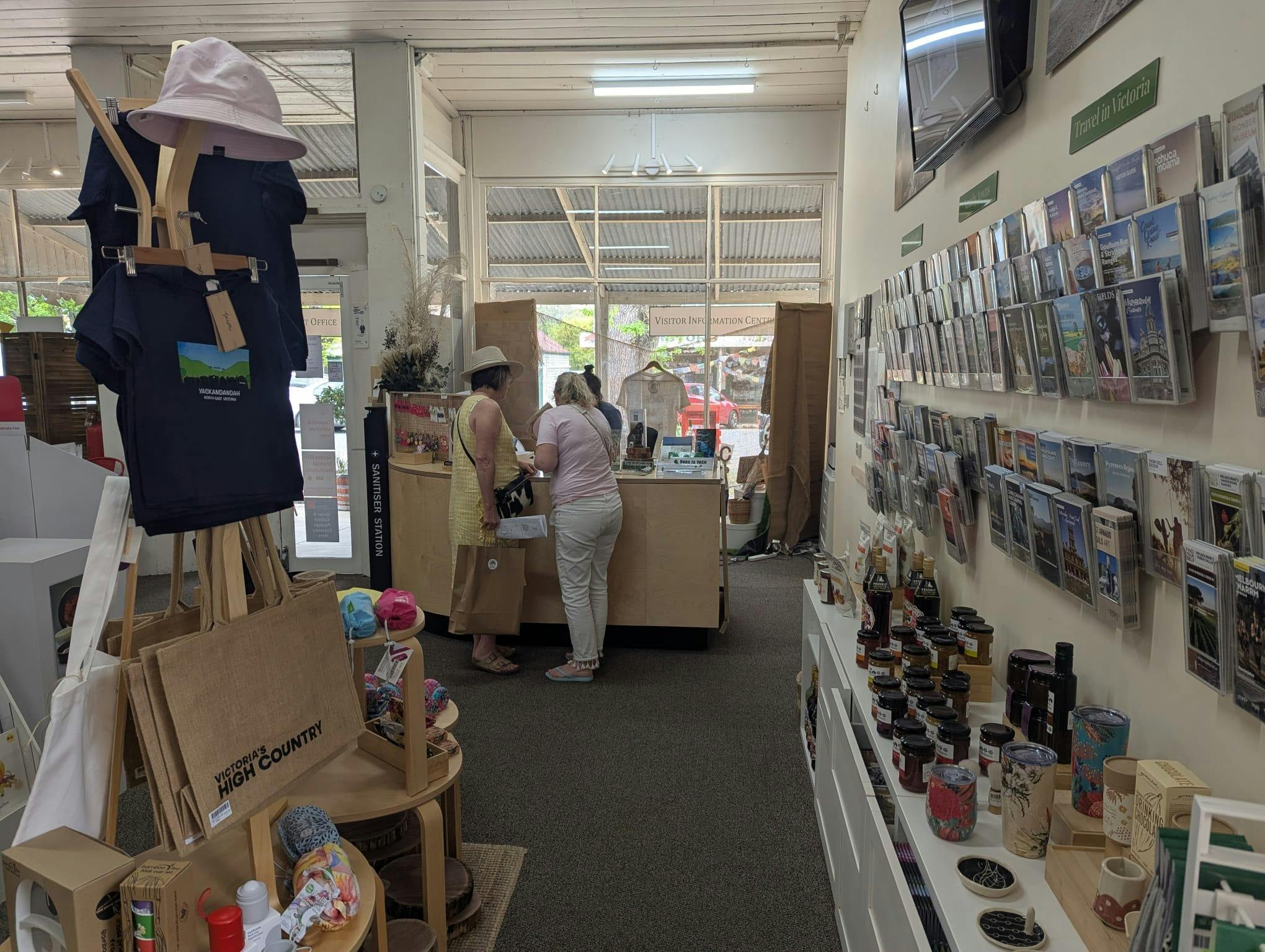 two people being assisted at the counter. A display stand with hessian bags in the foreground