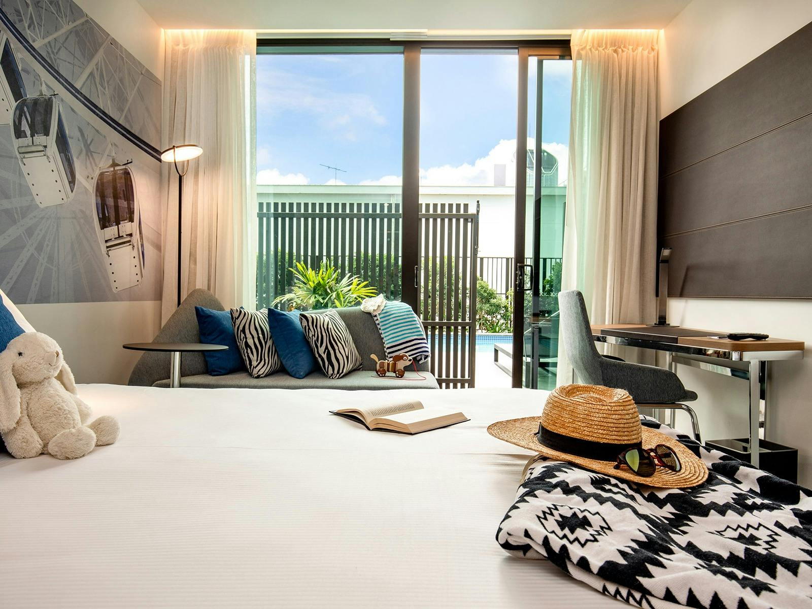 Room with bed with white bed sheets and view for the pool Room with bed with white bed sheets and view for the pool