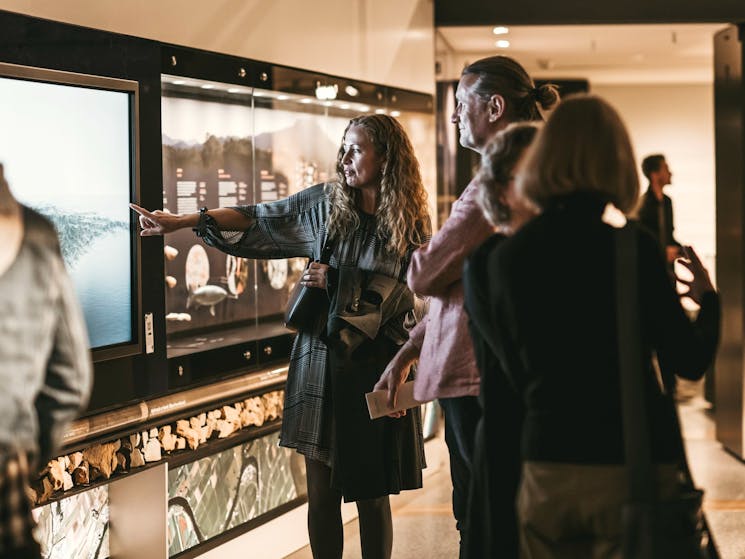 Visitors looking at Land Life Culture exhibition.