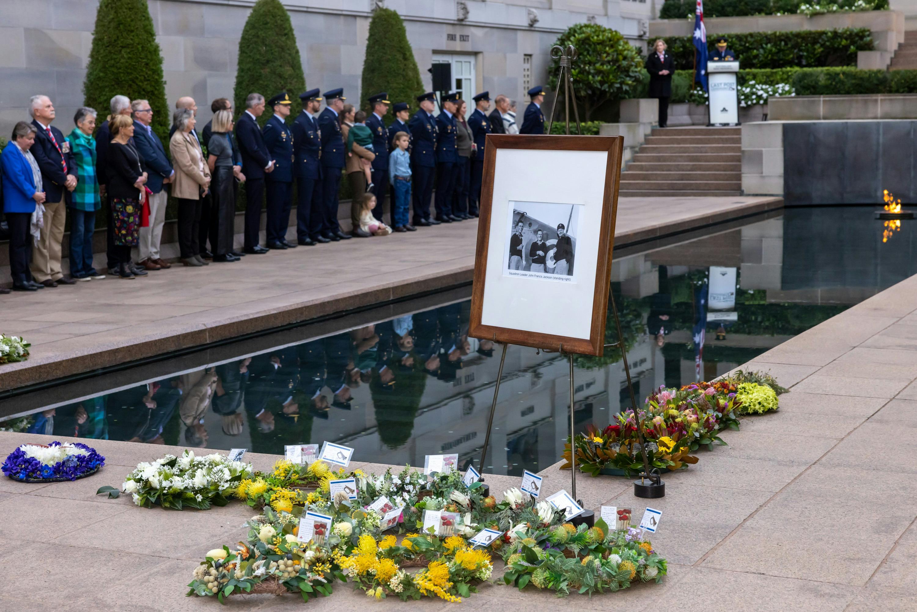 Wreaths at the base of the Pool of Reflection and photo in frame of person being commemorated.