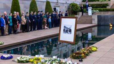 Wreaths at the base of the Pool of Reflection and photo in frame of person being commemorated.
