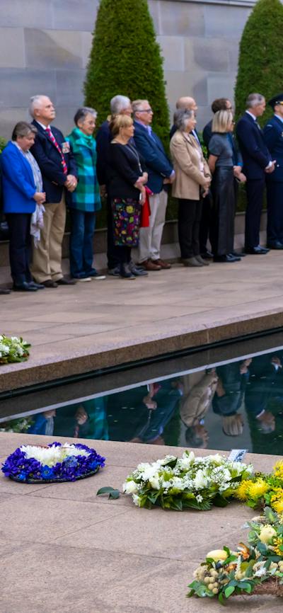 Wreaths at the base of the Pool of Reflection and photo in frame of person being commemorated.