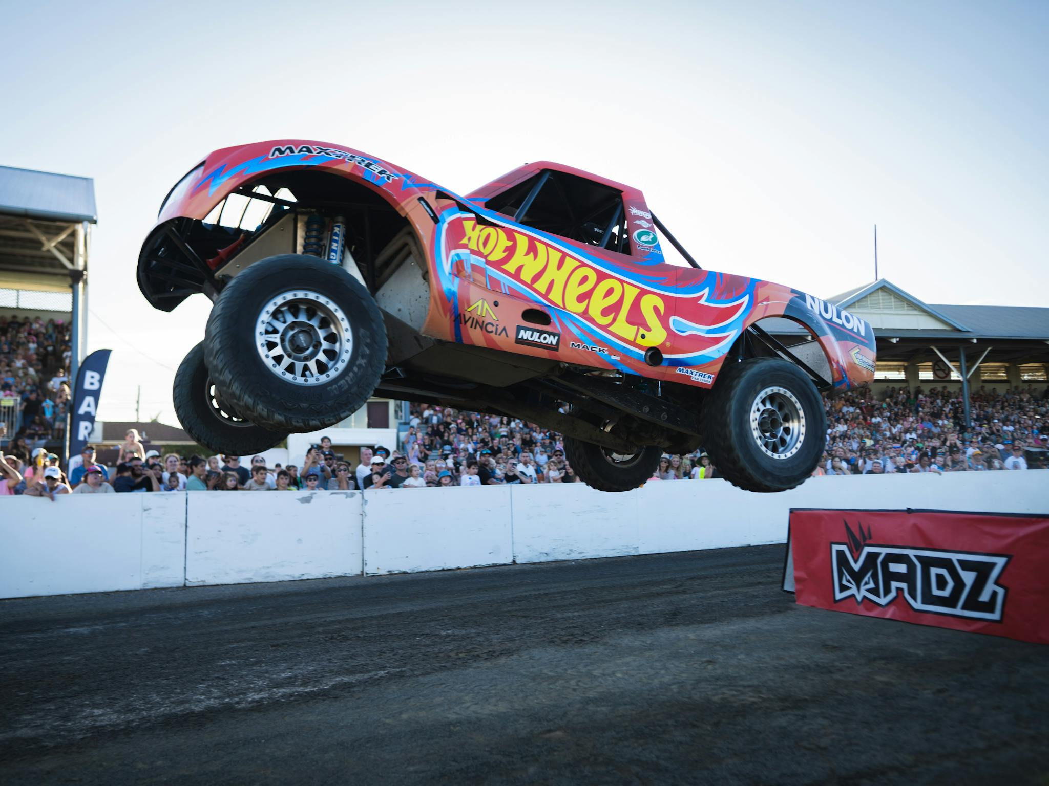 Hotwheels stunt team (car) performing in the centre ring with full public grandstand