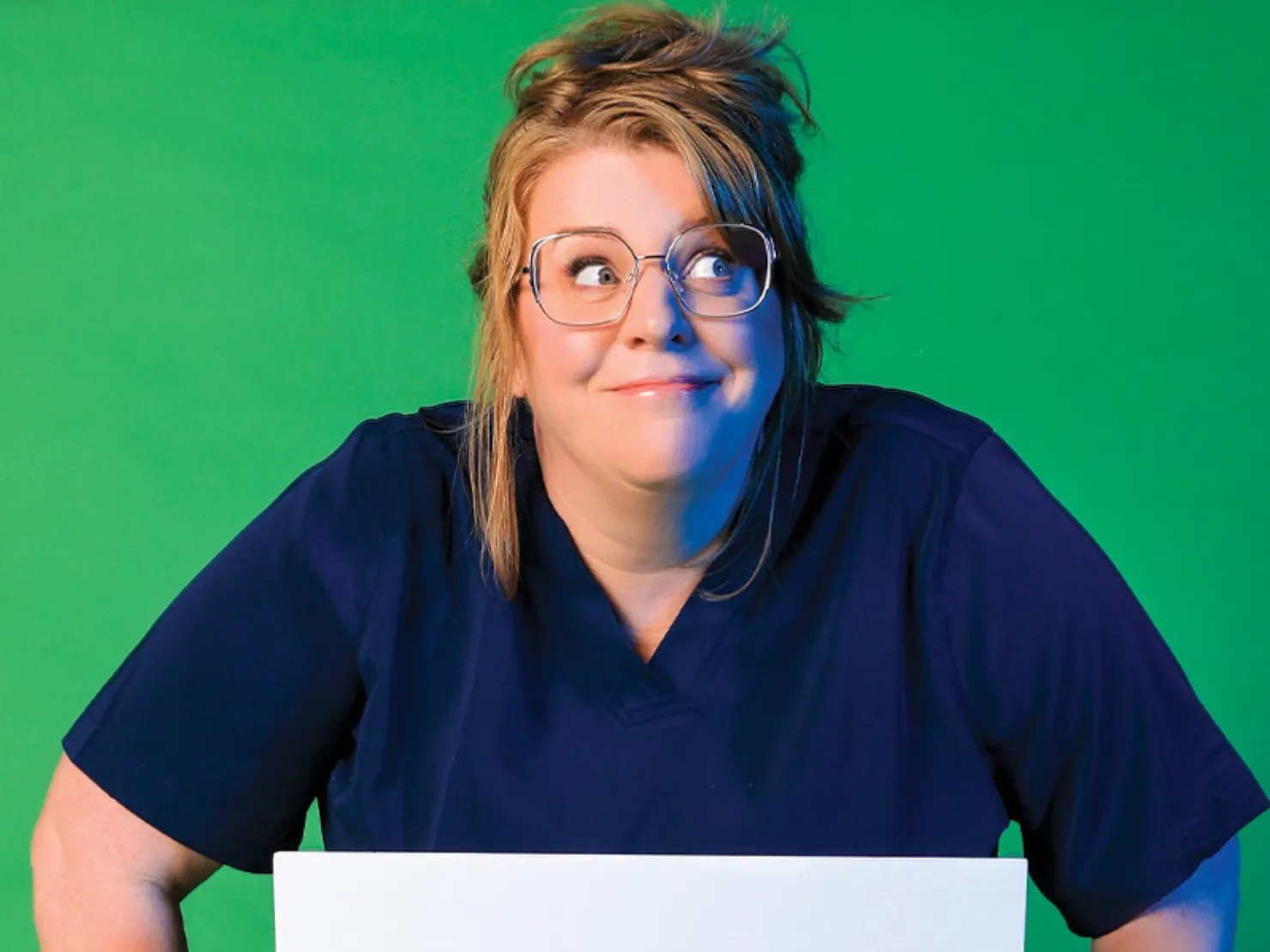 A middle aged lady wearing navy blue nurse uniform.