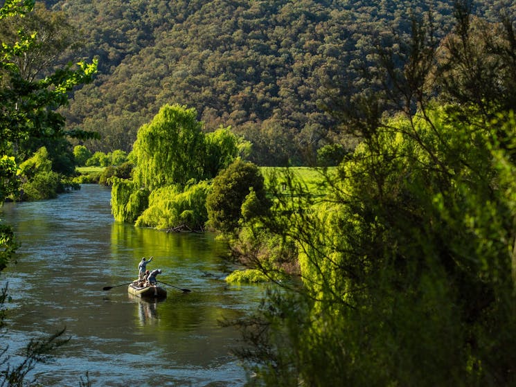 Fly fishing for trout on a drift boat on the Tumut river in the Snowy Mountains