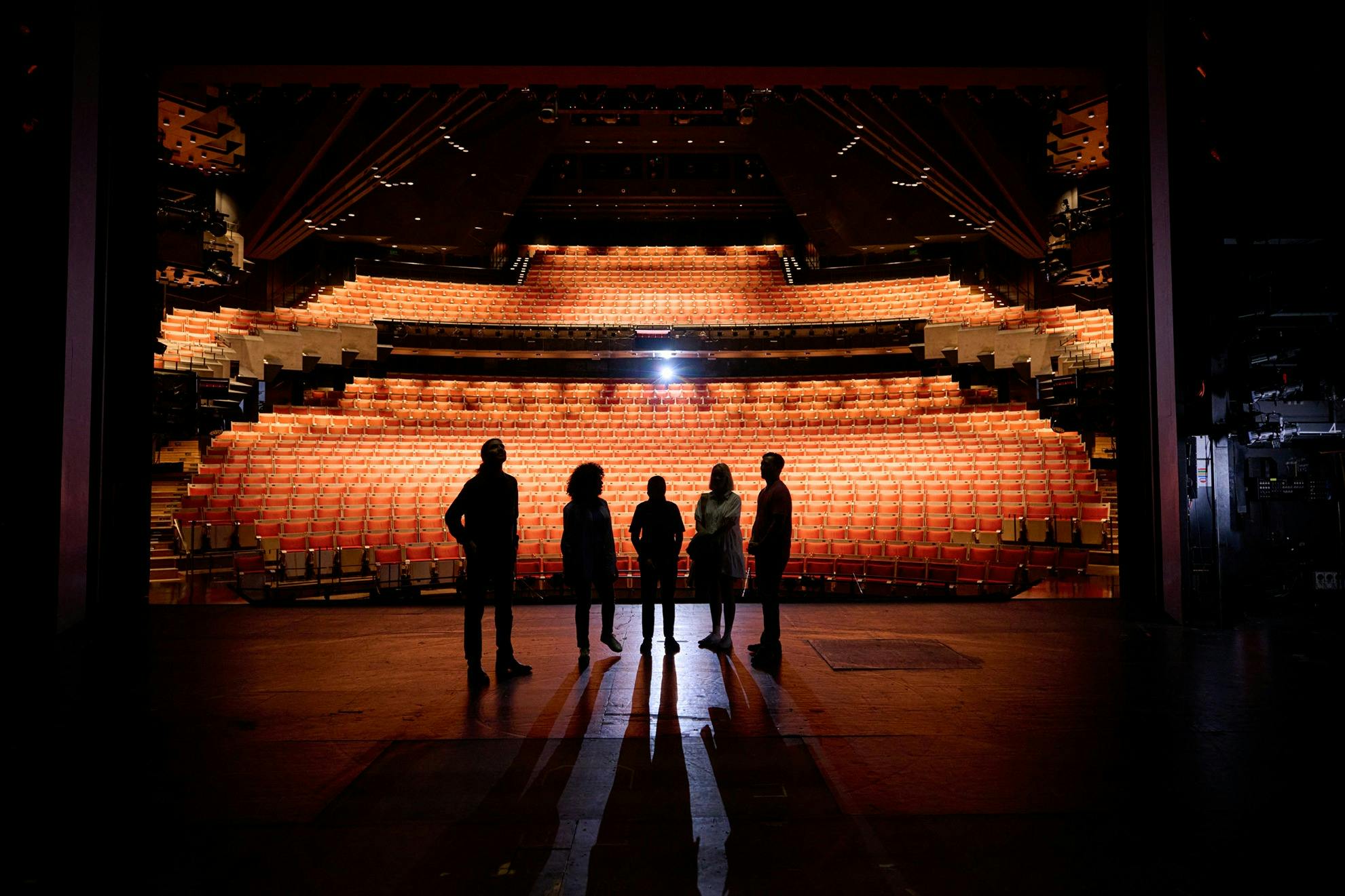 Tour guide and group standing on the Joan Sutherland Theatre stage
