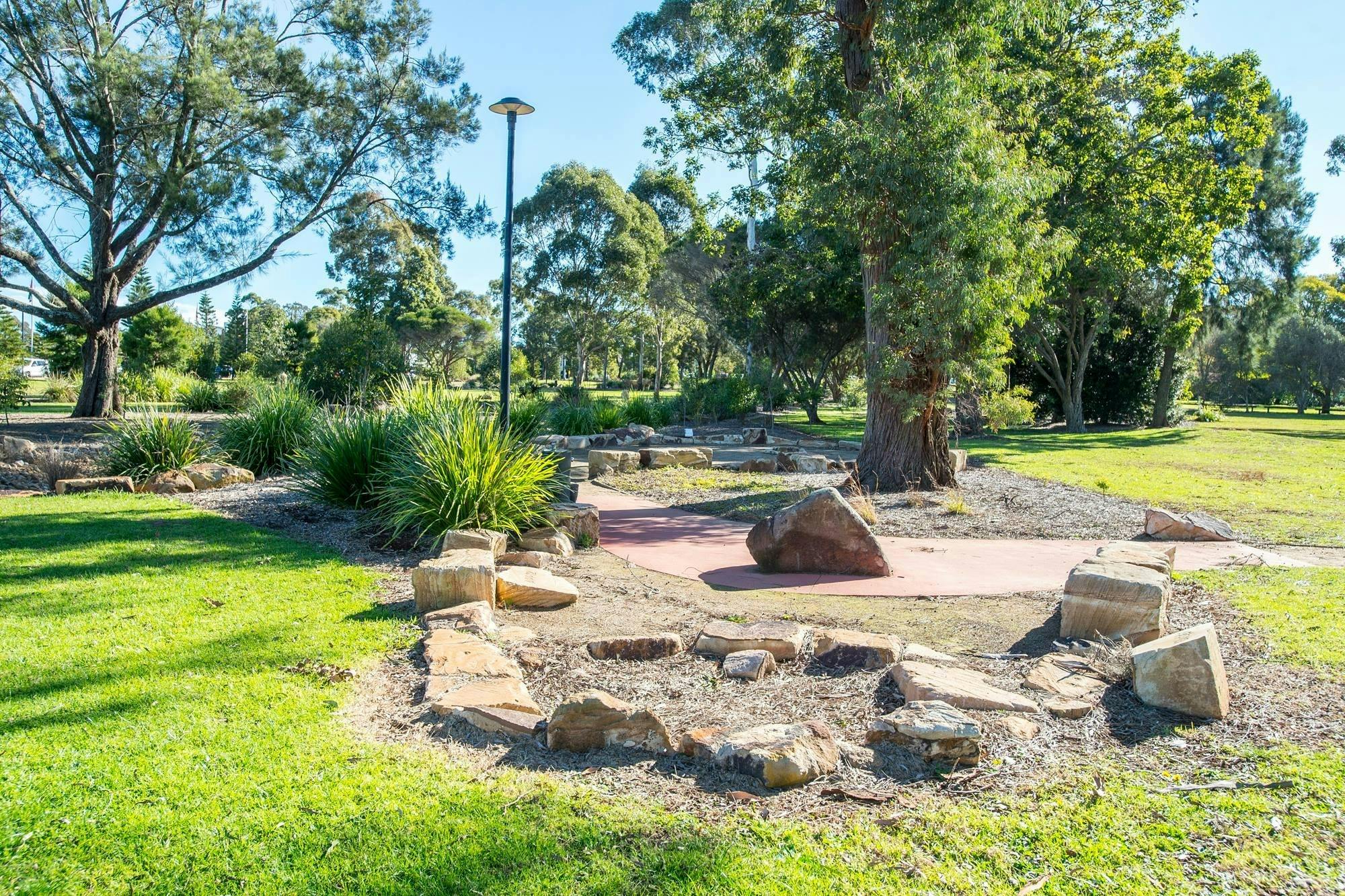 Green parkland with sandstones
