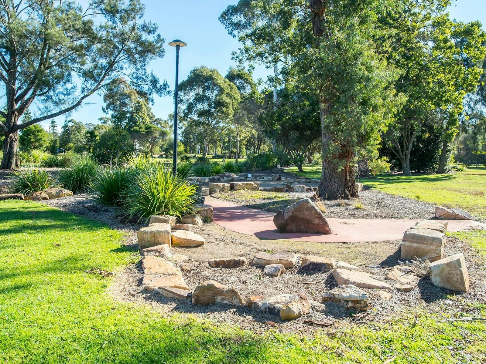 Green parkland with sandstones