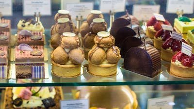 Display case of large and small cakes