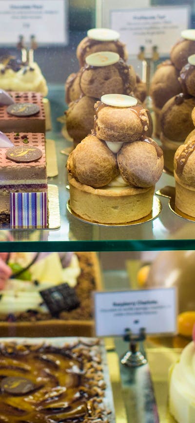 Display case of large and small cakes
