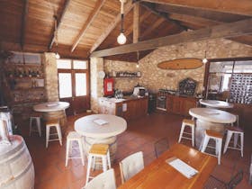 Birds-eye view of the Cape Jaffa Wines Cellar Door interior, featuring round stone tables, timber fi