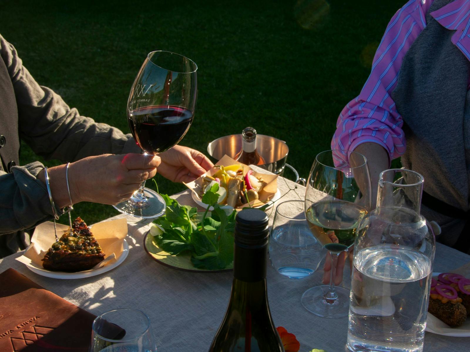 Guest with wine glass and food at table