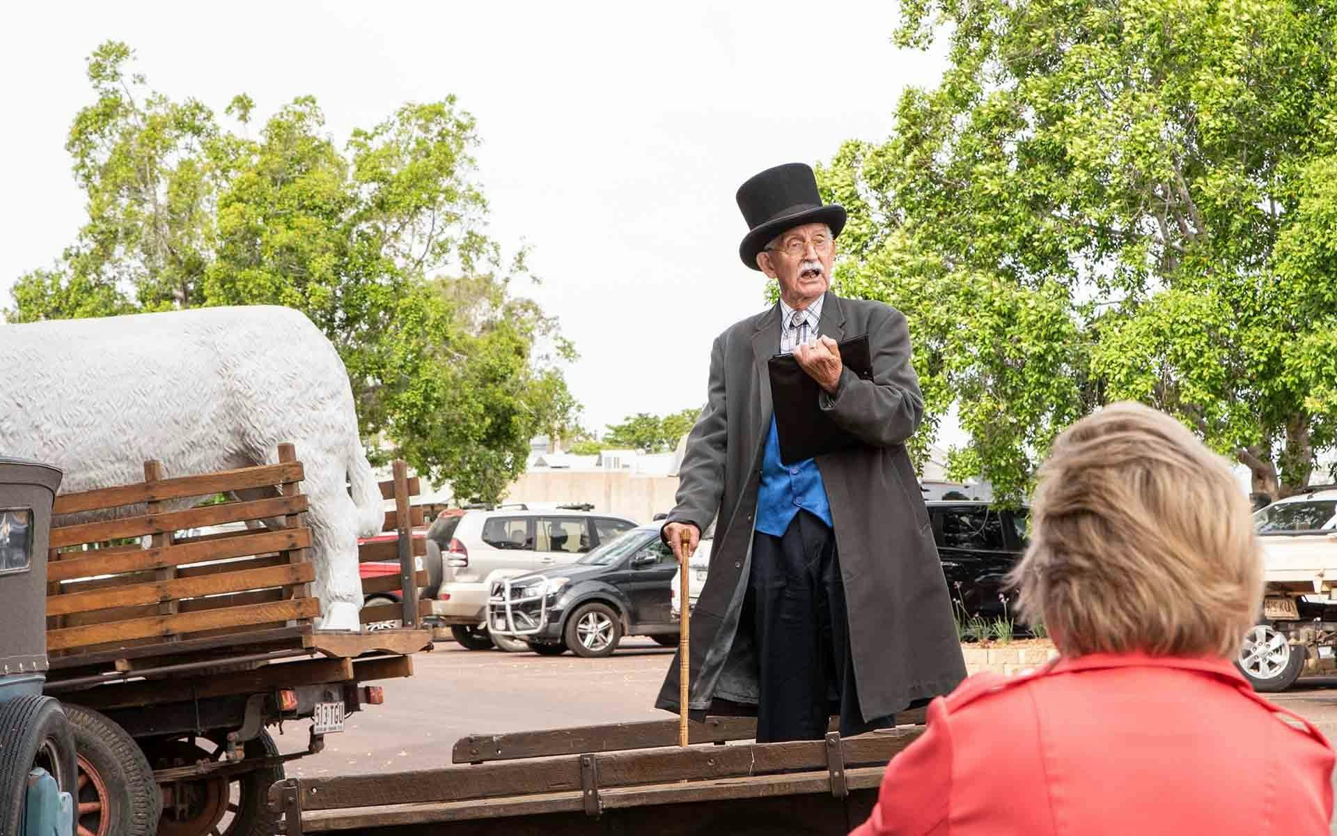 The town crier standing on a wagon
