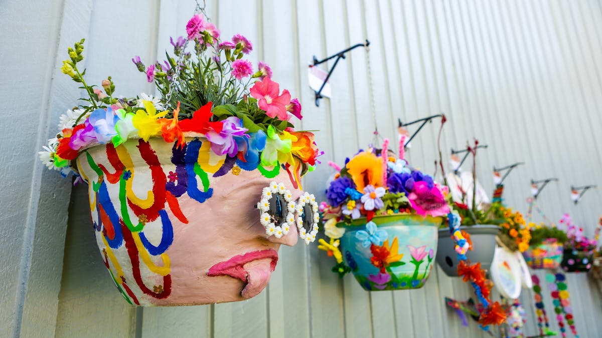 Row of hanging pot plants with colourful and unique designs. Row of hanging pot plants with colourful and unique designs.
