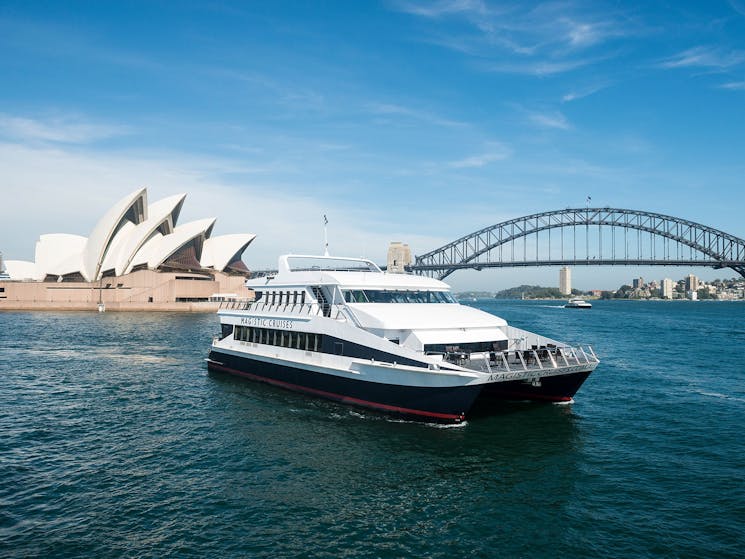 Magistic vessel on Sydney harbour with opera house and harbour bridge in the background.