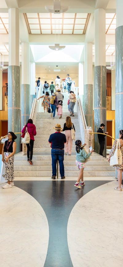 Many people standing in the Marble Foyer of Parliament House