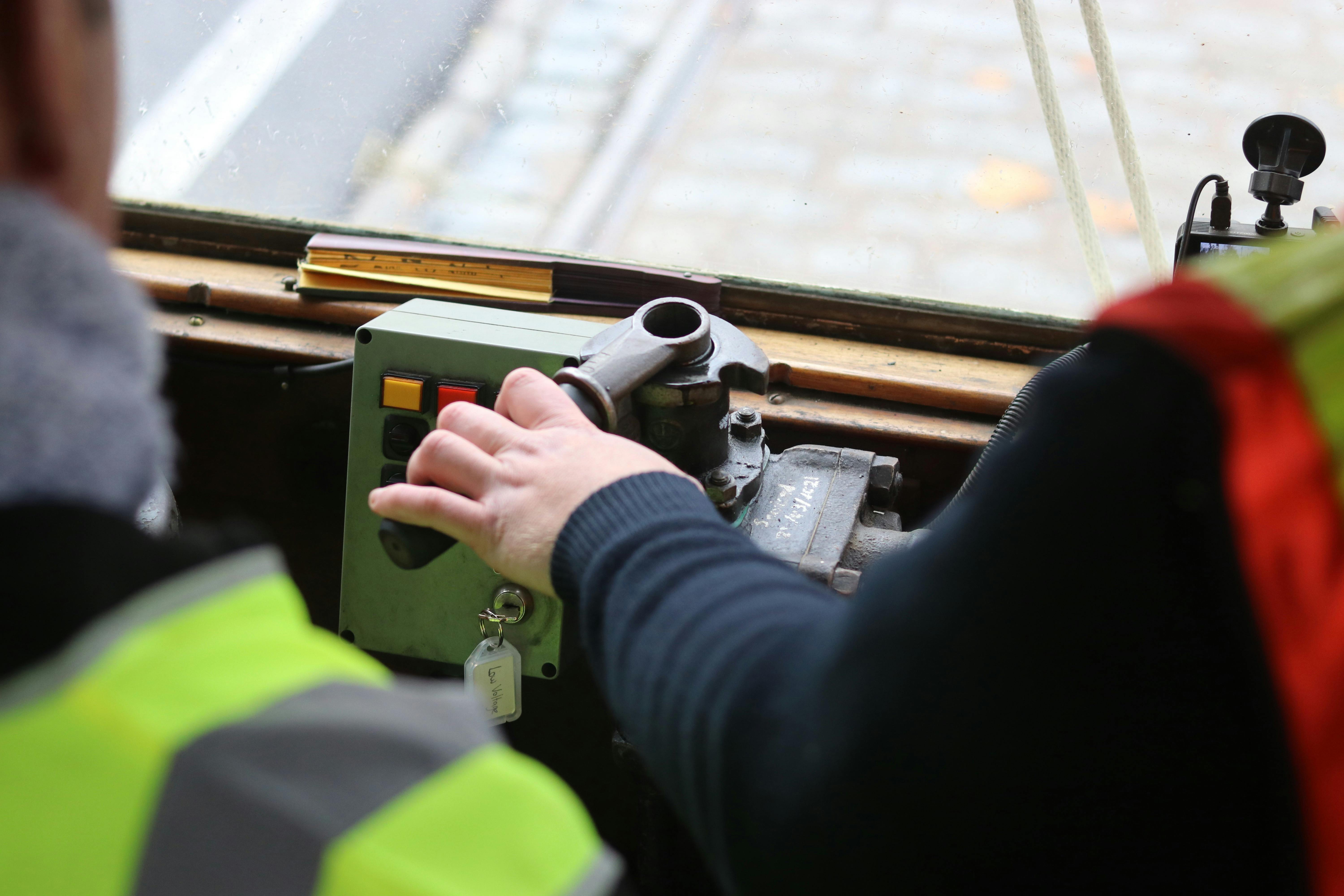 Hands on the tram controls