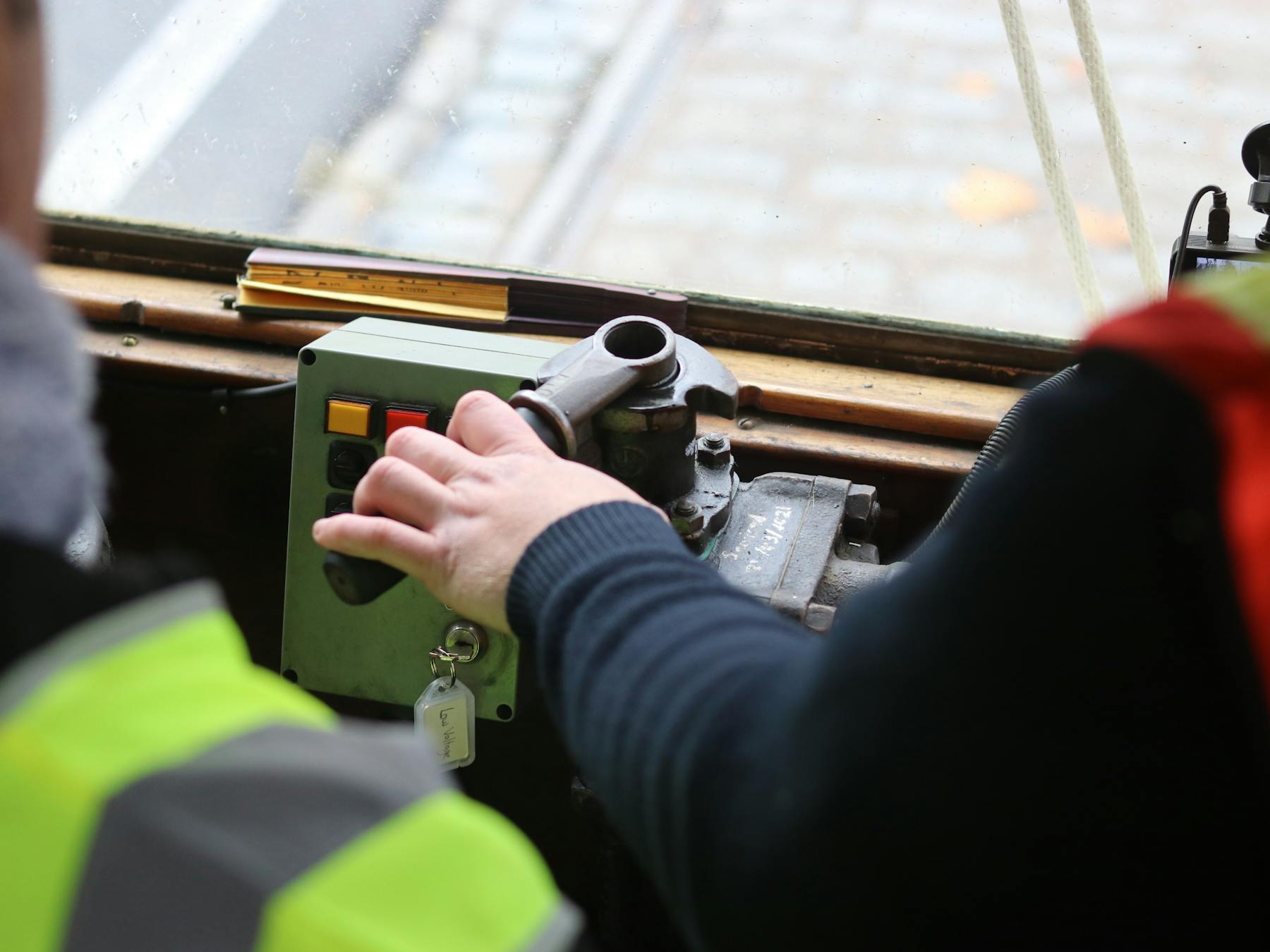 Hands on the tram controls