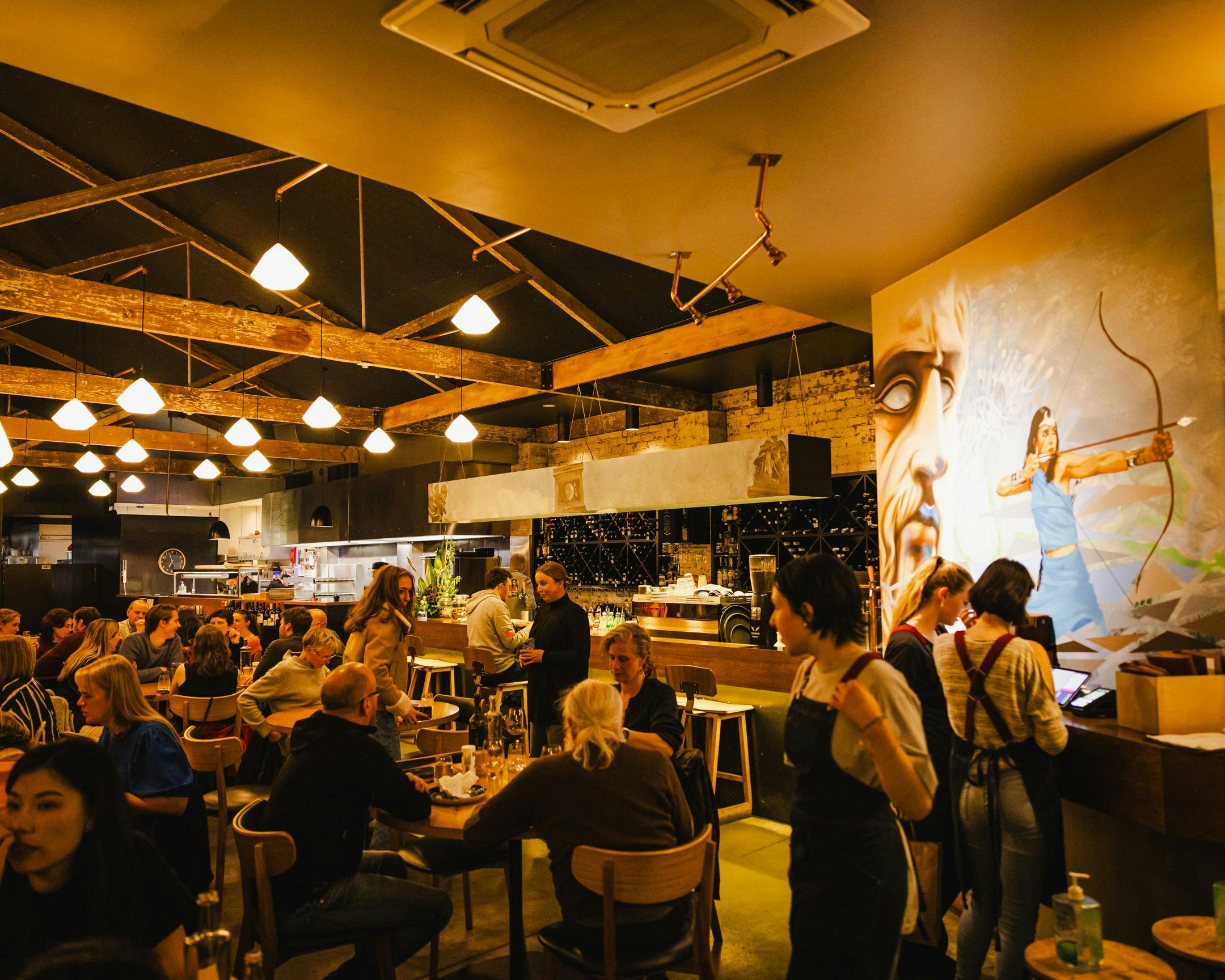 Interior of Urban Greek restaurant in Hobart filled with diners enjoying authentic Greek food.