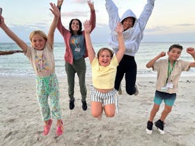 Access Adventure Club participants, with children jumping and having fun