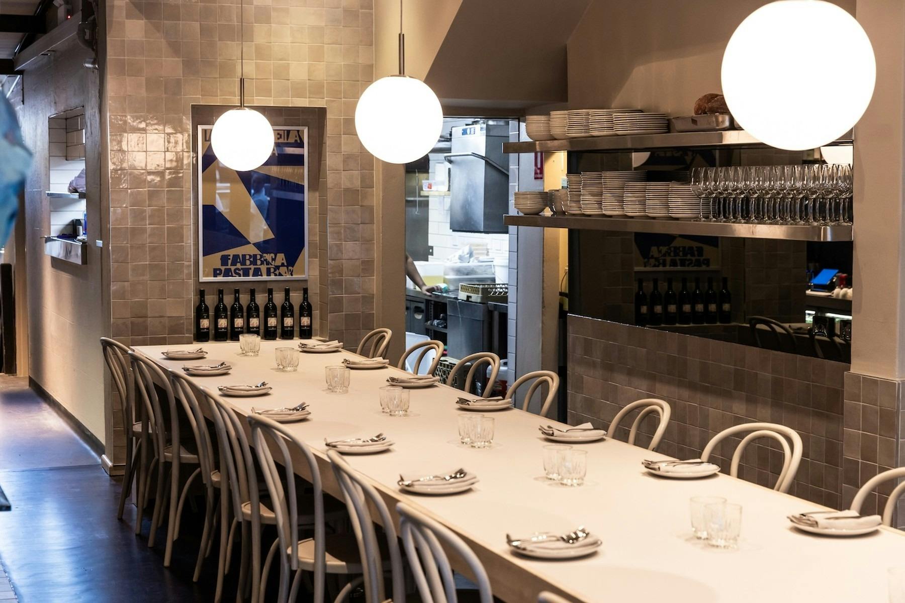 A large communal dining table with settings