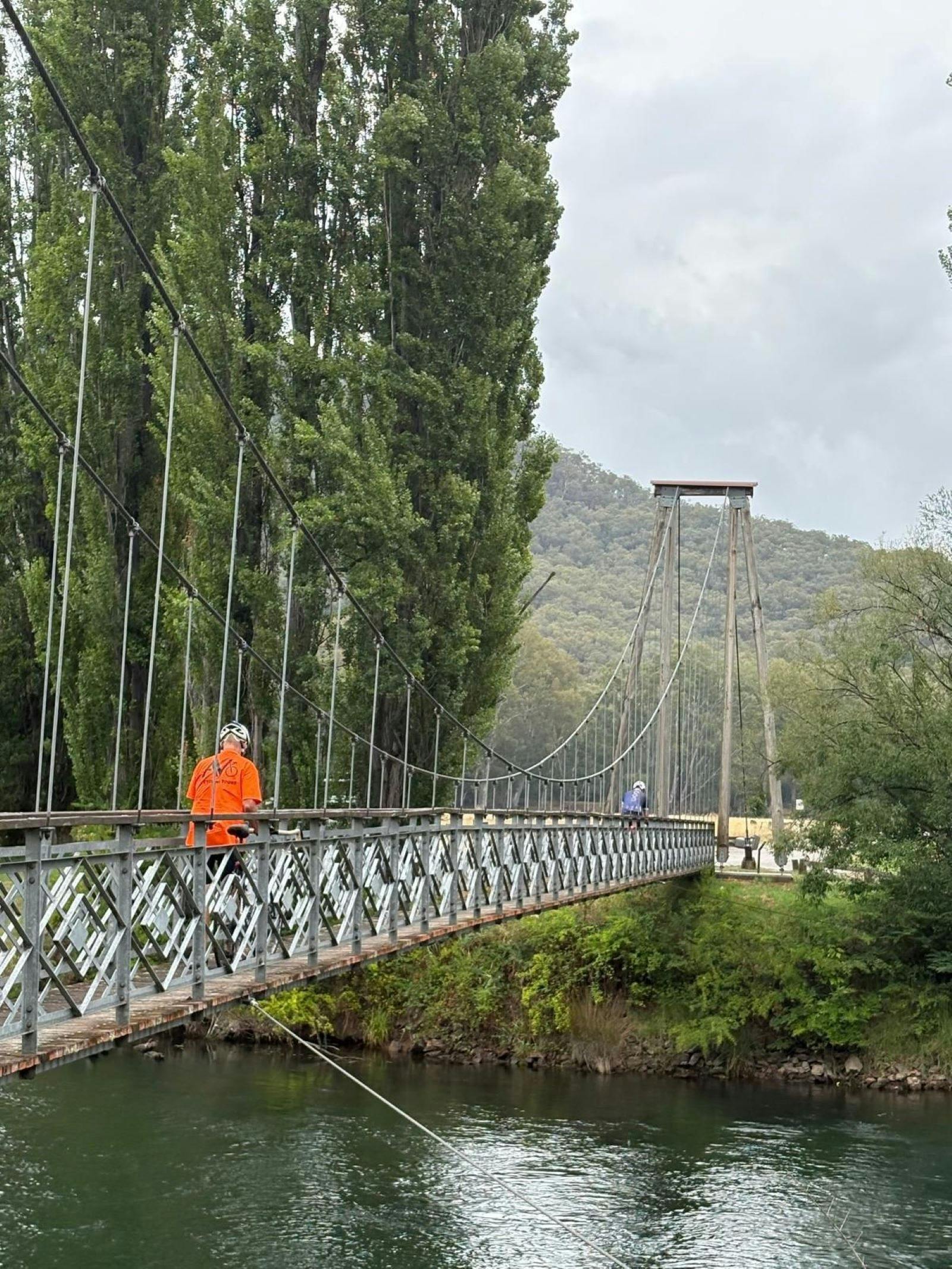 cyclist on swing bridge Tumut River