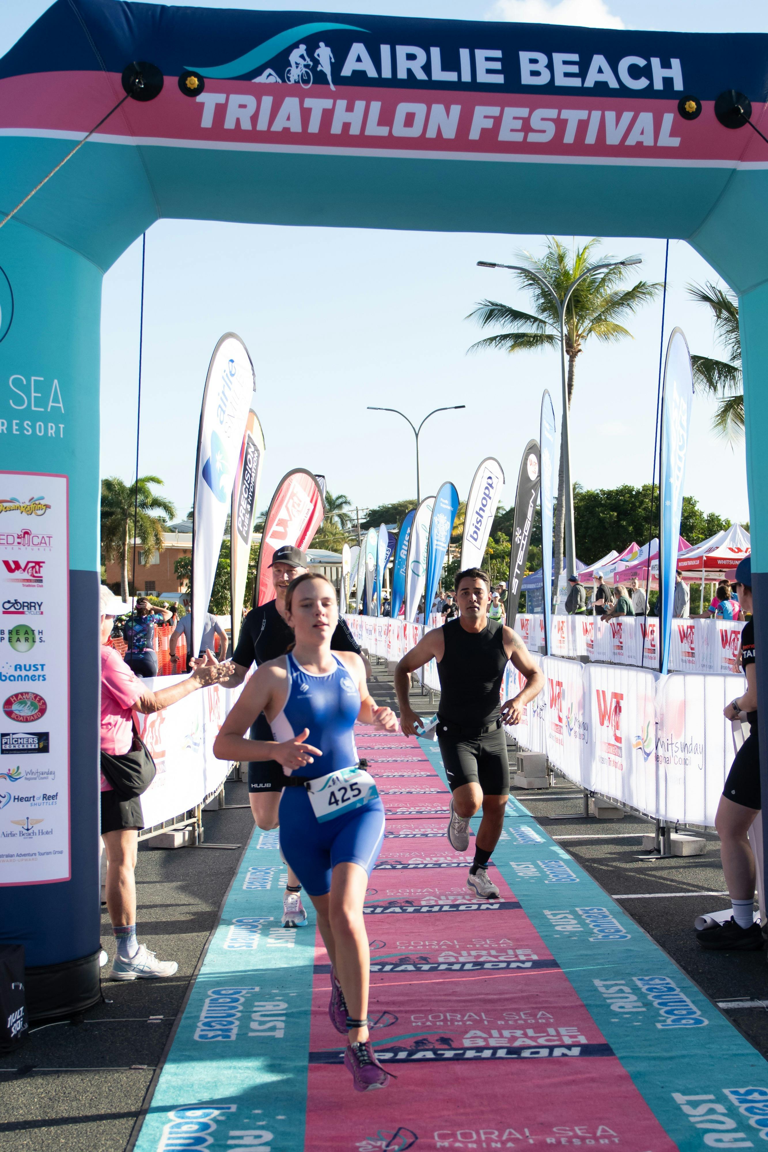Finish line crossing by three athletes