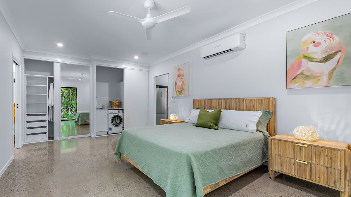 Queen size bed and bedside tables.  Wardrobe with hanging space and shelves, plus washing machine